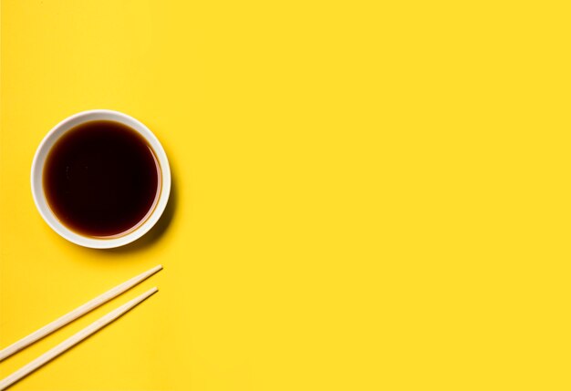 Top view minimalist soy sauce with chopsticks