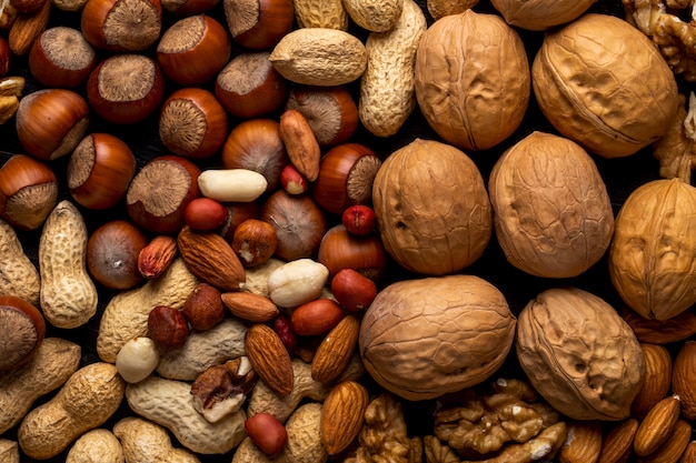 Free photo top view mix of nuts peeled and inshell