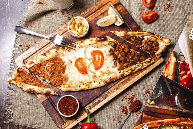 Top view of mixed pide with minced meat ground beef and cheese