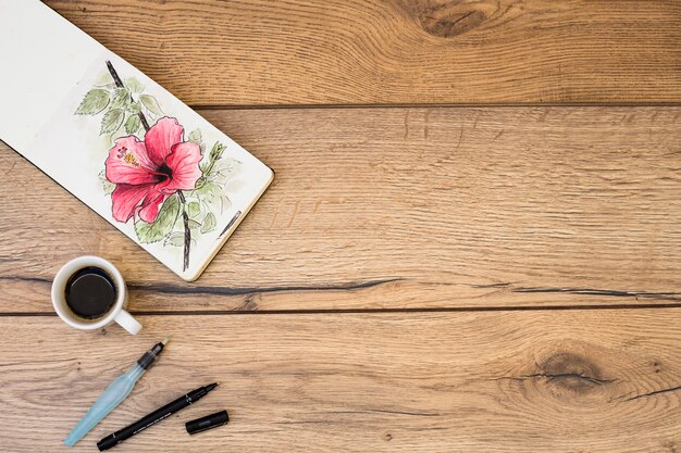 Top view of modern artist desk with watercolor equipment