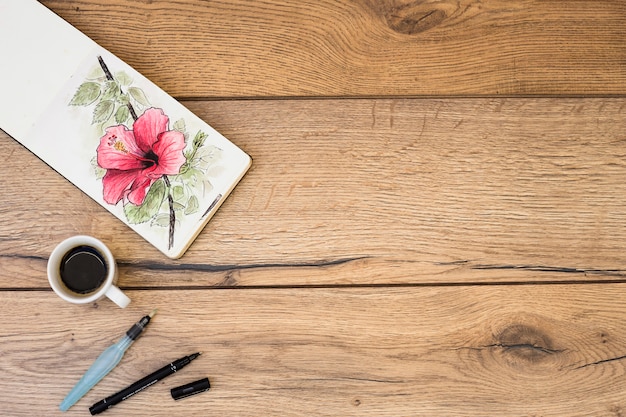 Top view of modern artist desk with watercolor equipment