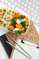 Free photo top view modern workplace arrangement with food close-up