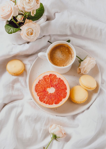 Top view of morning coffee with grapefruit and macarons