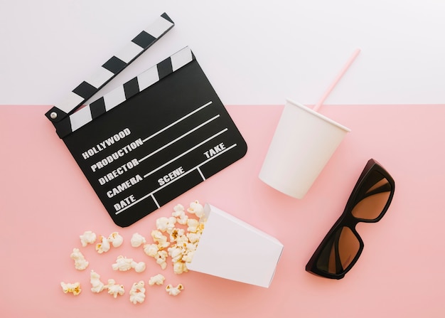 Top view movie clapperboard with popcorn