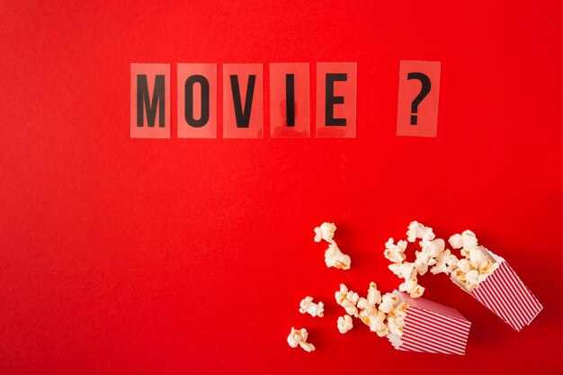 Top view movie lettering on red background with copy space