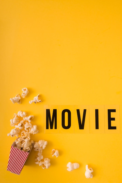 Top view movie lettering on yellow background with copy space