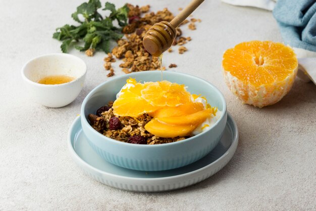 Top view of muesli with oranges in bowl