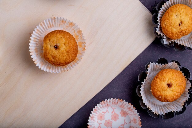 Top view of muffins in paper molds on rustic