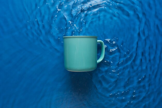 Free photo top view over mug floating on water