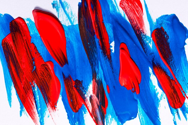 Top view of multicolored paint brush strokes on surface