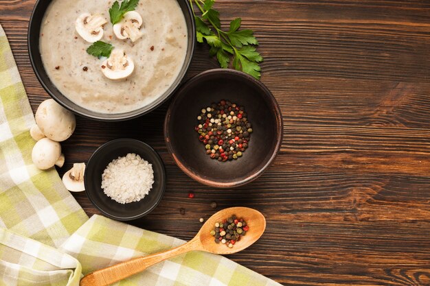 Top view mushrooms bisque condiments and spoon