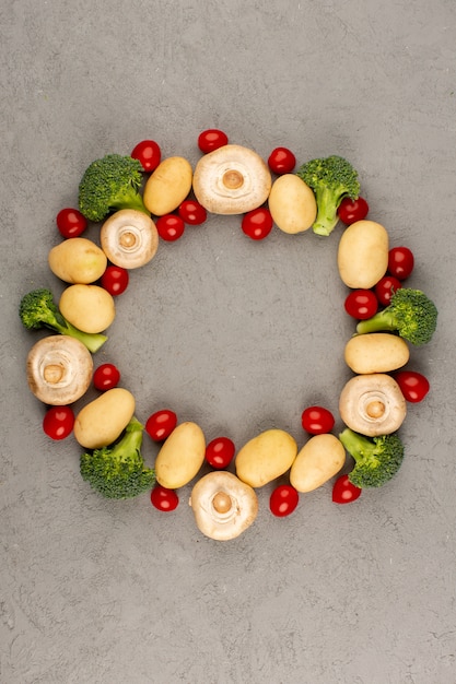 top view mushrooms tomatoes broccoli fresh ripe colorful vegetables on the grey floor