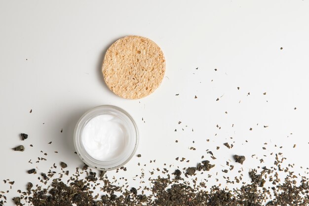 Top view of natural cream and herbs on white background