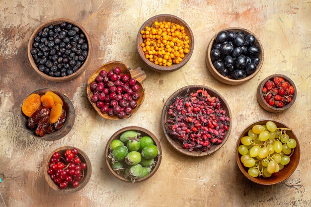 Top view of natural and fresh various fruits in small brown wooden pots