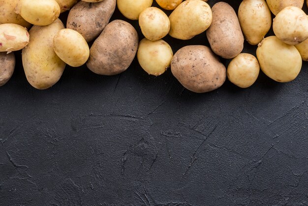 Free photo top view natural potatoes with copy-space