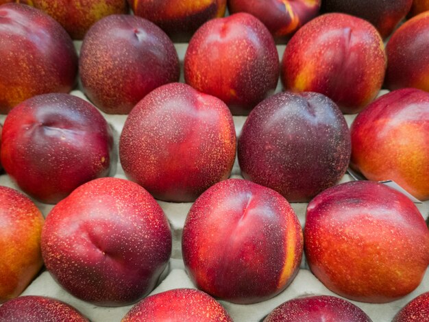 Top view of nectarines on a white surface