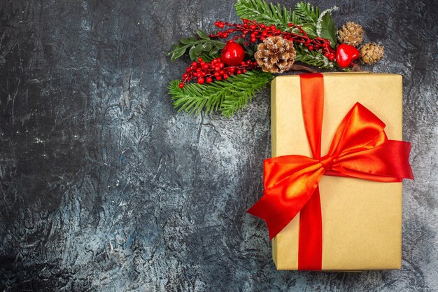 Top view of new year gift with red ribbon and acessories decorations on dark surface