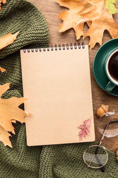 Top view of notebook and autumn leaves