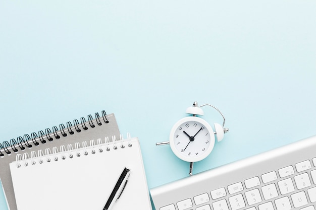 Top view notebook and clock arrangement