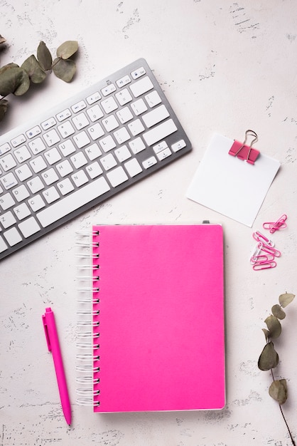 Free photo top view of notebook on desk with keyboard and dried leaves