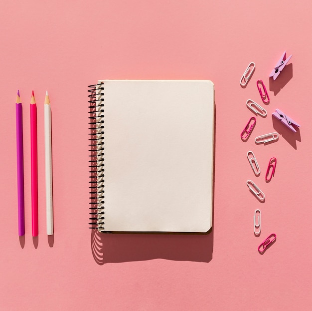 Top view notebook and paper clips