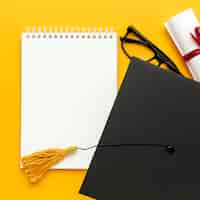 Free photo top view of notebook with academic cap and glasses