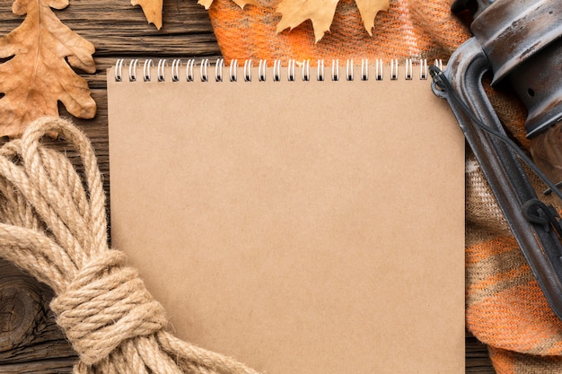 Free photo top view of notebook with autumn leaves