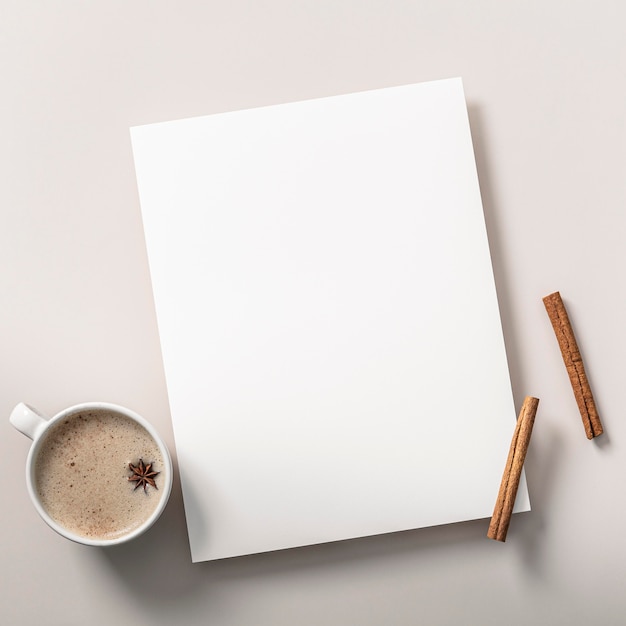 Top view of notebook with cinnamon sticks and coffee cup