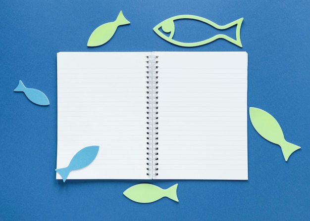 Top view of notebook with fish