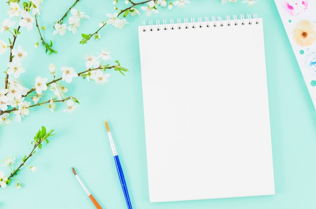 Free photo top view notebook with flower branch