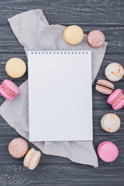 Top view of notebook with macarons