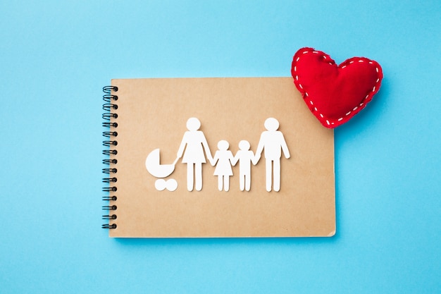 Top view notebook with paper cut family concept