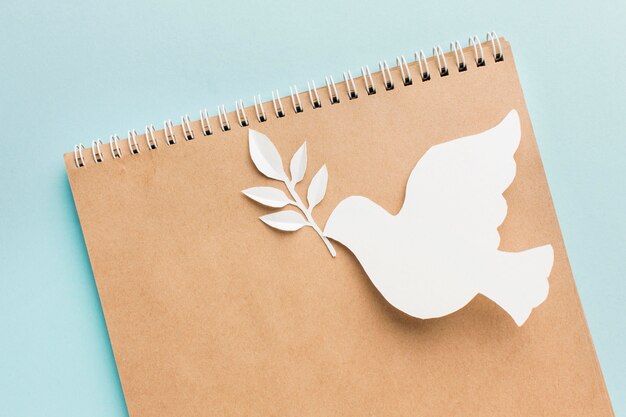 Top view of notebook with paper dove