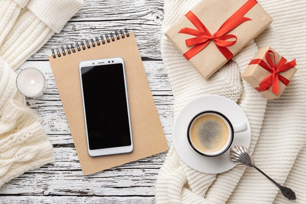 Top view of notebook with smartphone and cup of coffee