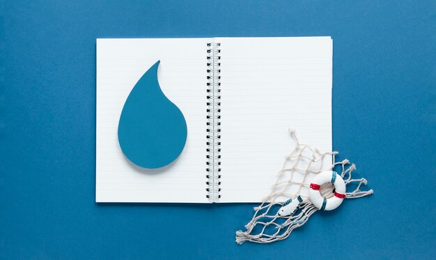 Top view of notebook with water drop and fishing net