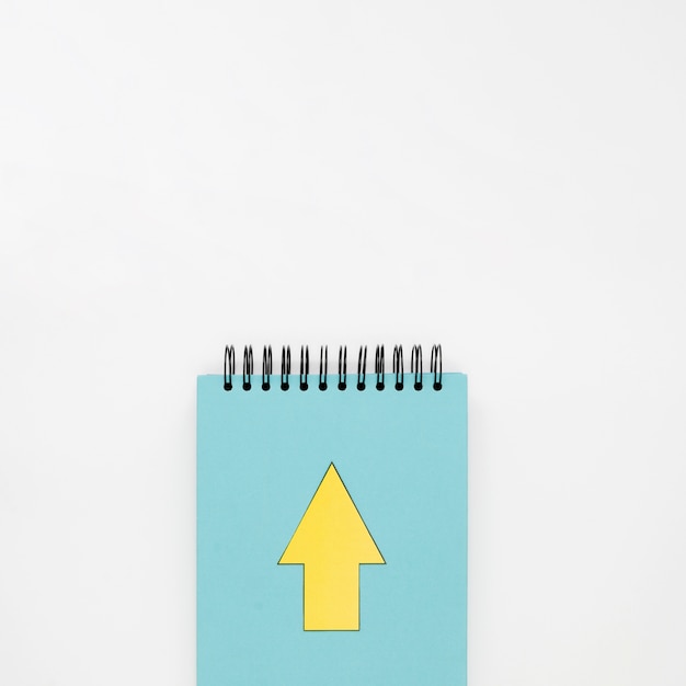 Top view of notebook with yellow arrow