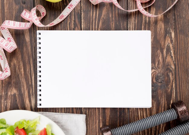 Top view notebook on wooden background