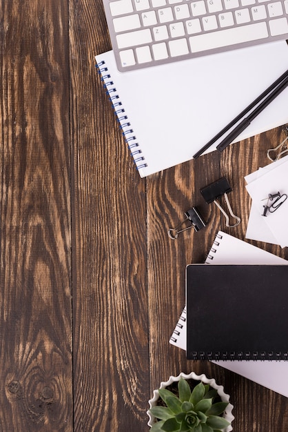 Top view of notebooks on wooden desk with copy space