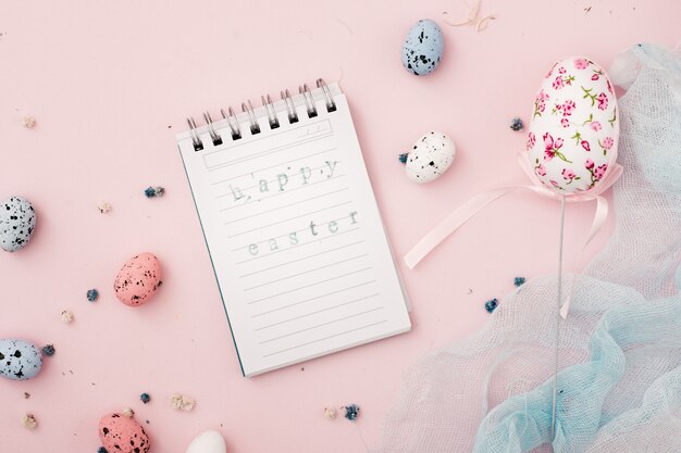 Top view notepad paper with easter greeting