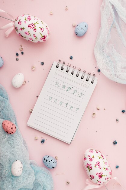 Top view notepad paper with easter greeting