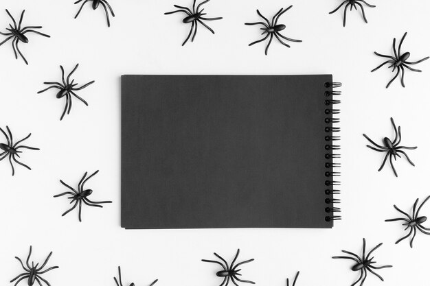 Top view notepad surrounded by spiders