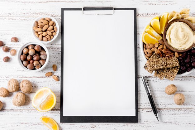 Top view of notepad with assortment of nuts and cereal bars