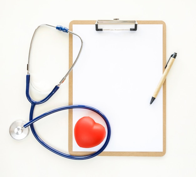 Top view of notepad with heart shape and stethoscope