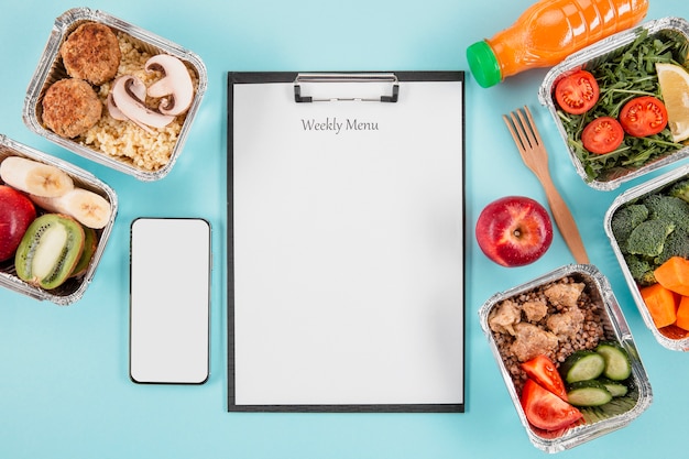 Free photo top view of notepad with meals and smartphone