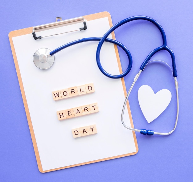 top view of notepad with paper heart and stethoscope