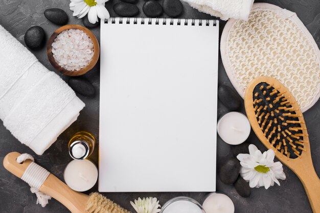 Top view notepad with spa brush and candles