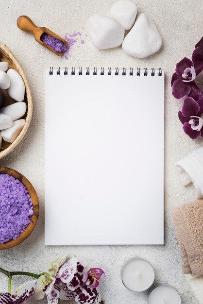 Top view notepad with spa stones and candles