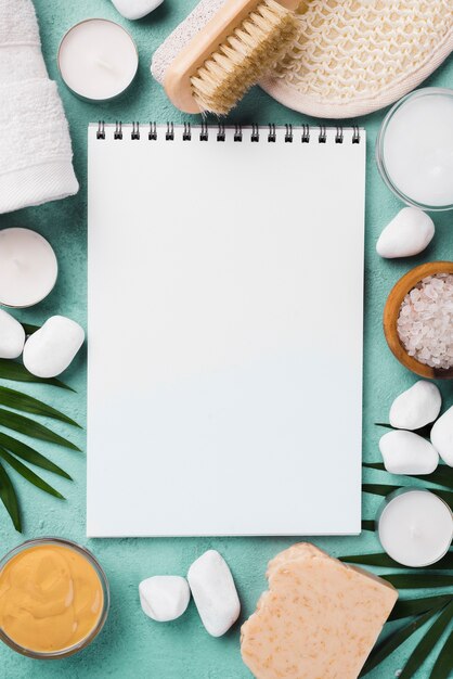 Top view notepad with spa stones and candles