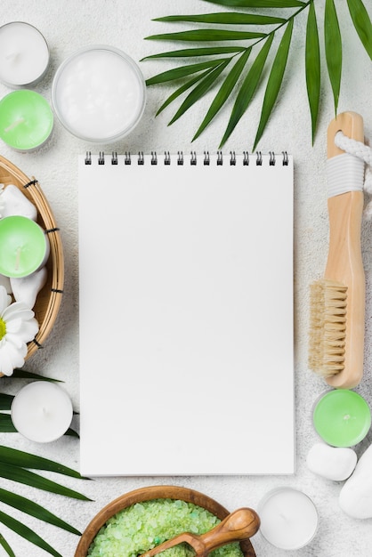 Top view notepad with wellness stones and candles