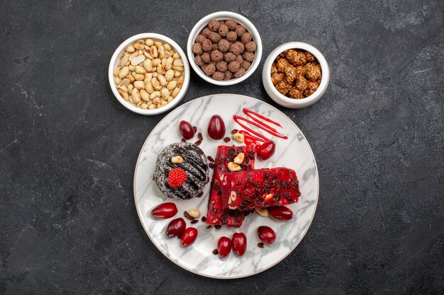 Top view nougat slices with nuts on dark-grey space